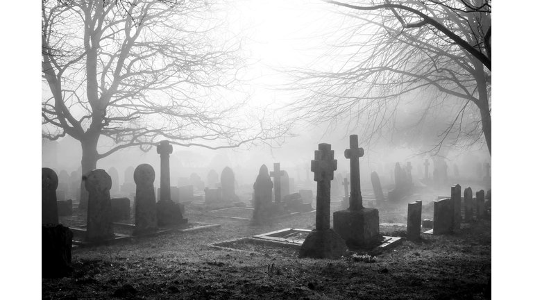 misty grave yard with tombstones