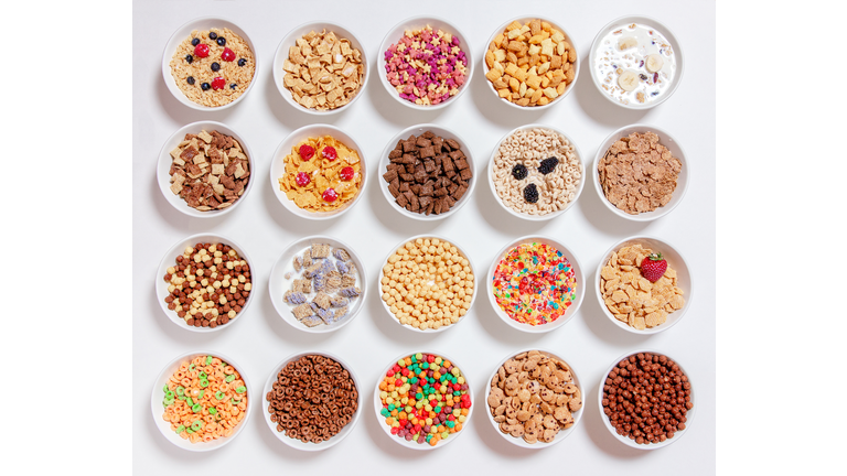 set of different cereals with milk on a white background