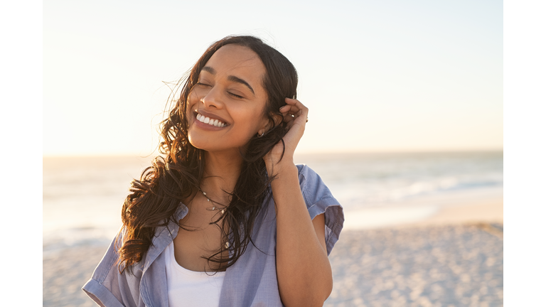 Carefree beautiful latin woman relaxing on beach