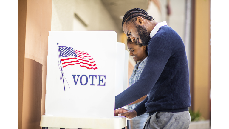 Millenial Black Man and Woman Voting in Election