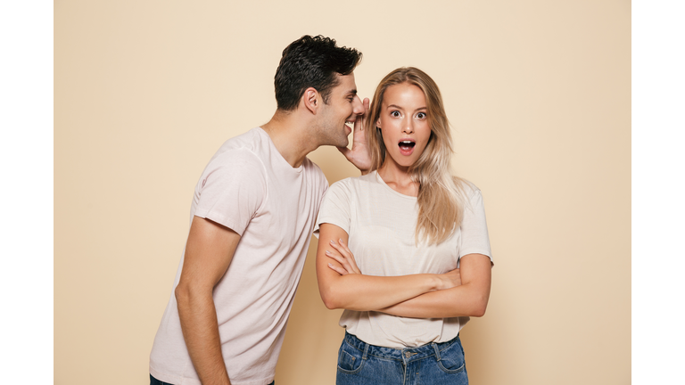 Portrait of a shocked young couple standing together