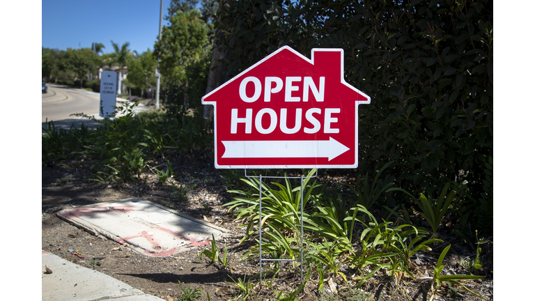 Red open house sign in the shape of a house