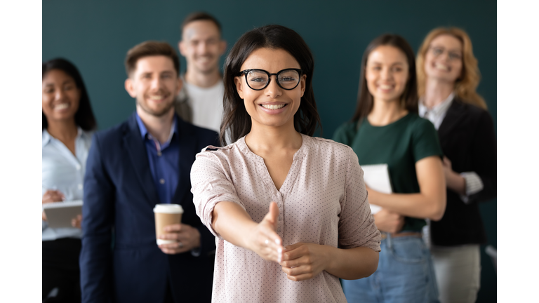 Mixed race woman sales manager stretch out hand greeting client