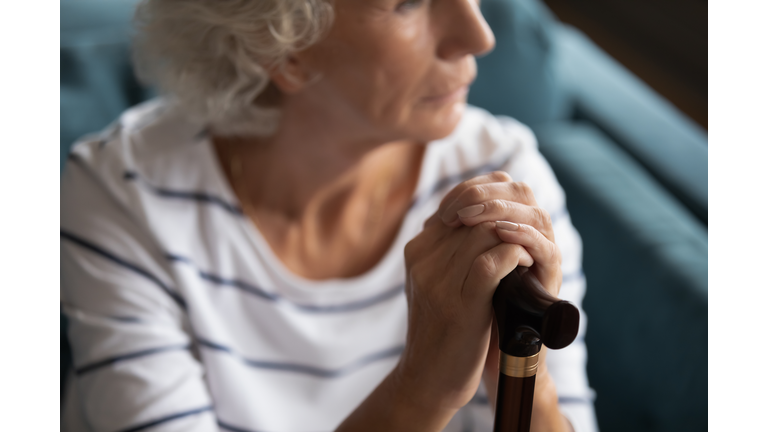 Unhappy older senior grandmother having walking disability.