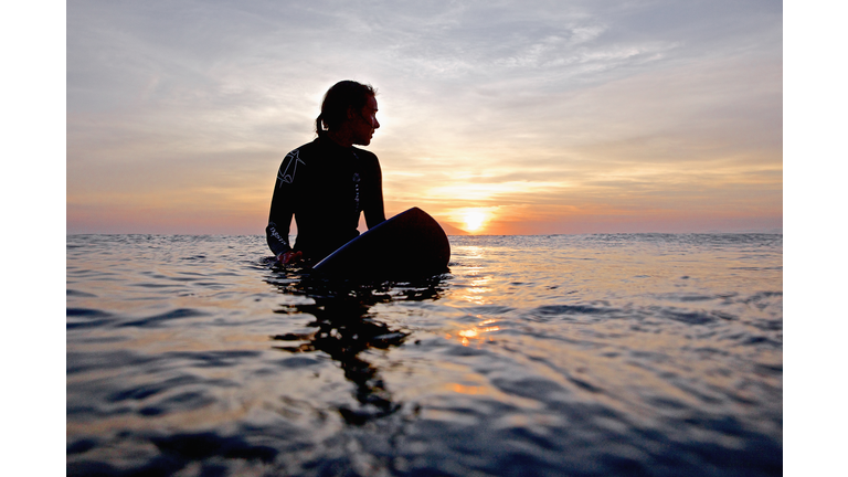 Female surfer waiting for wave, Praia, Santiago Island, Cape Verde