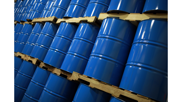 Blue Metal Oil Barrels Stacked In A Warehouse