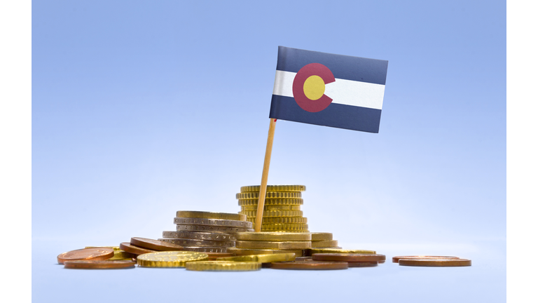 Flag of Colorado in a stack of coins.(series)