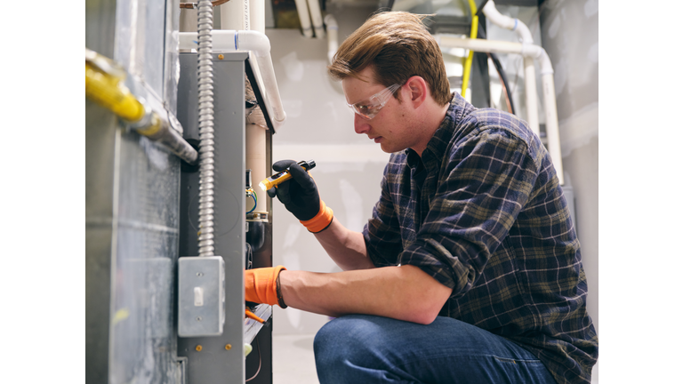 Home Repairman Working on a Furnace