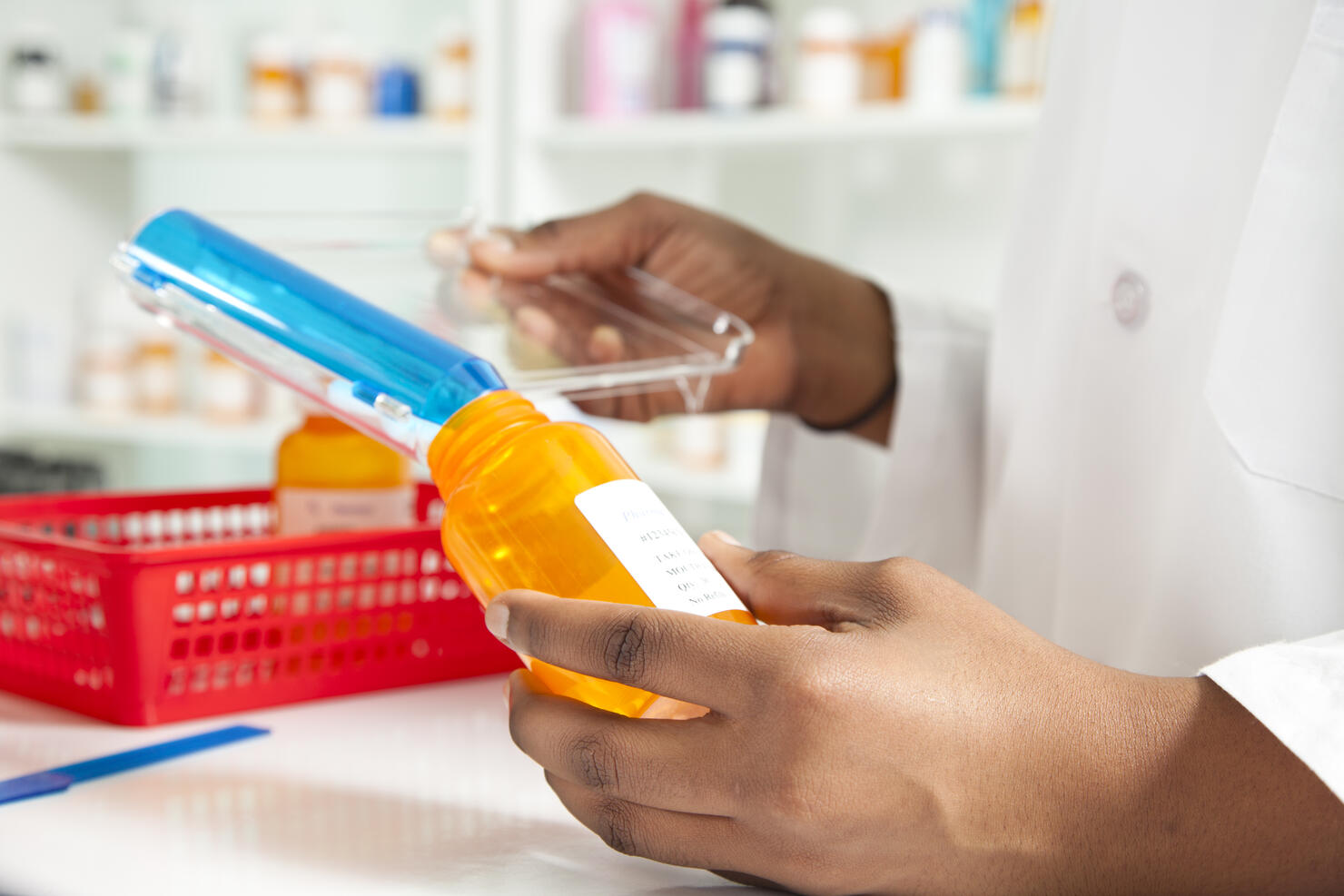 Pharmacist filling bottle for a prescription