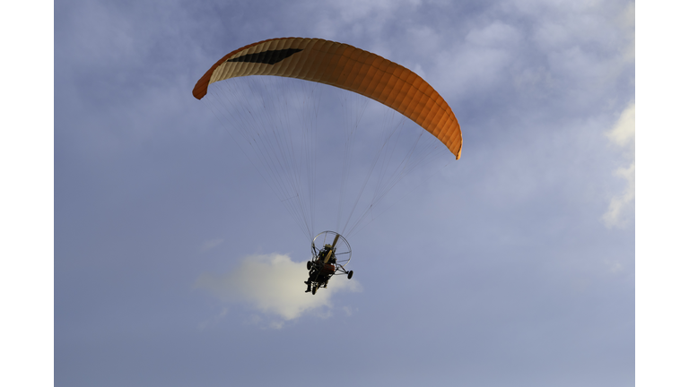 paramotor on blue sky background