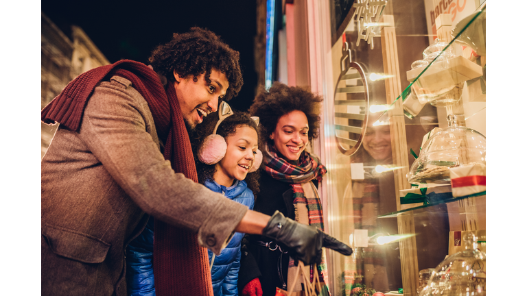 Smiling young family looking at candy and Christmas presents