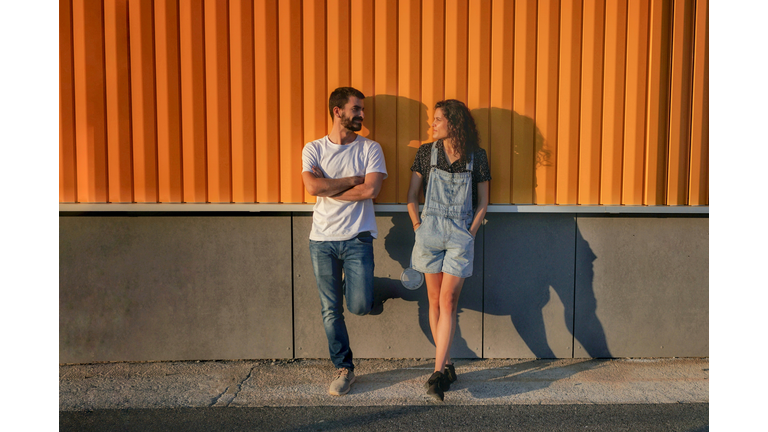 Full Length Of Friends Standing Against Wall