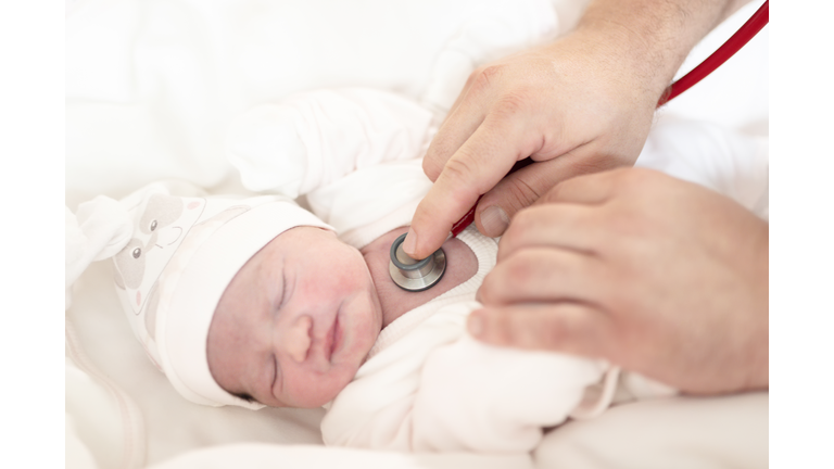 Newborn baby and doctor
