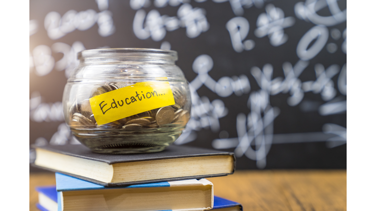 Many money coin in the glass jar with 'Education" wording