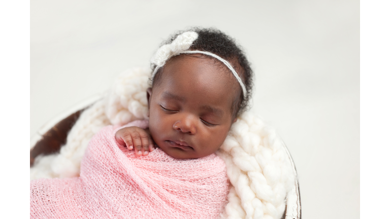 Newborn Baby Girl Sleeping in Bowl