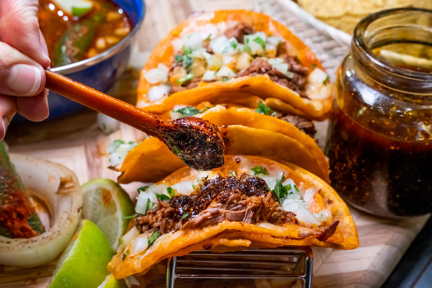 Authentic Gourmet Birria Tacos And A Bowl Of Delicious Mexican Consume, Soup, Arranged On A Wood Cutting Board