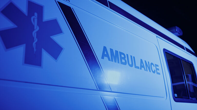 Closeup emergency body of car with logo. Ambulance vehicle with emblem