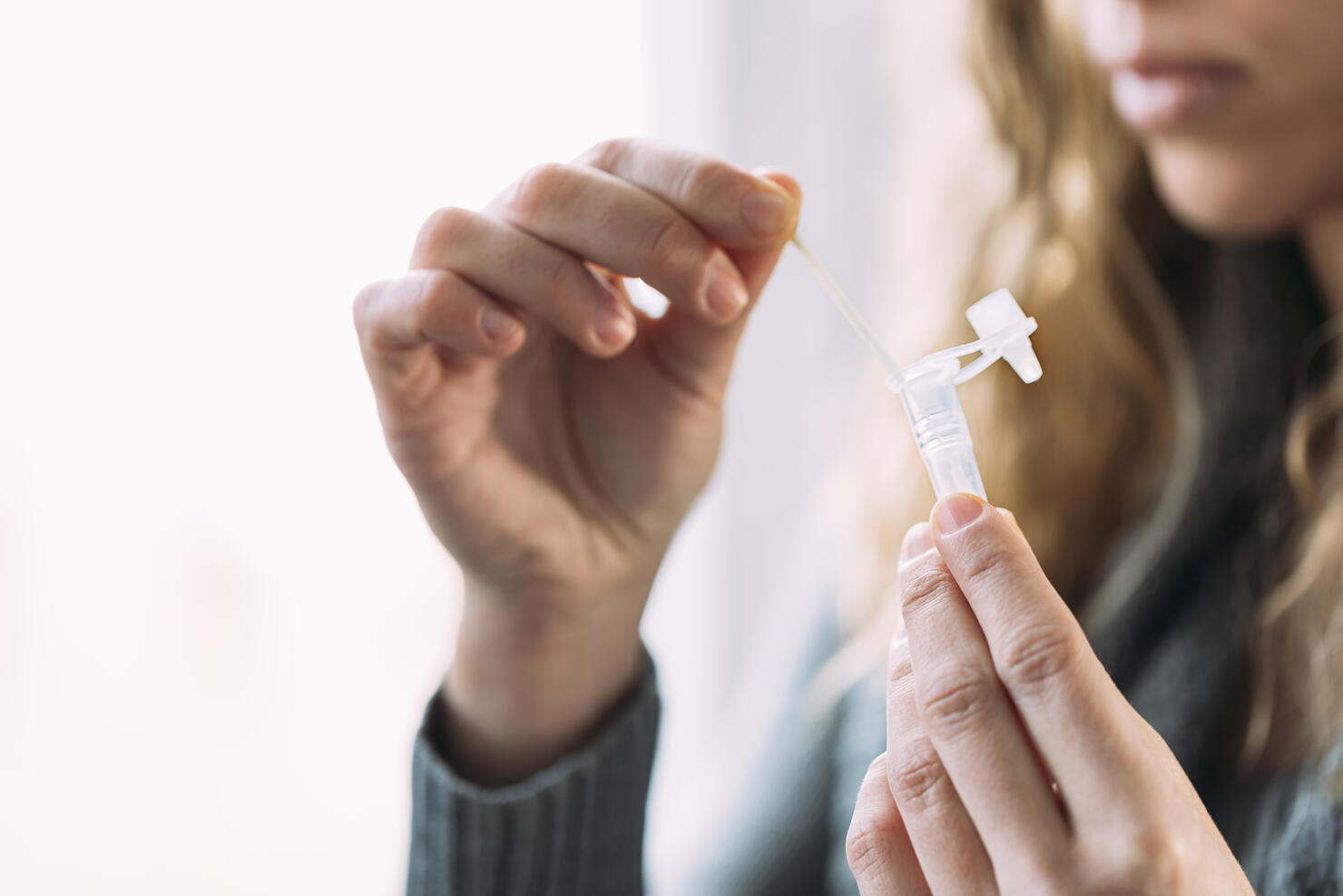 Woman doing antigen auto-test at home