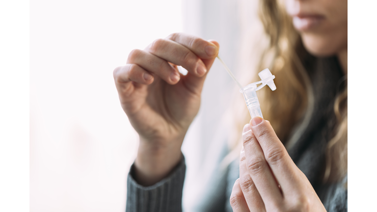 Woman doing antigen auto-test at home
