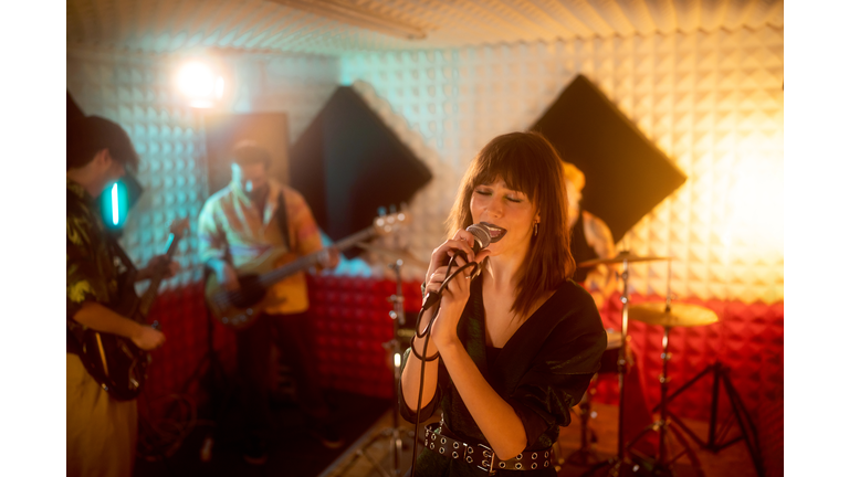 Rock band having rehearsal at the music recording studio
