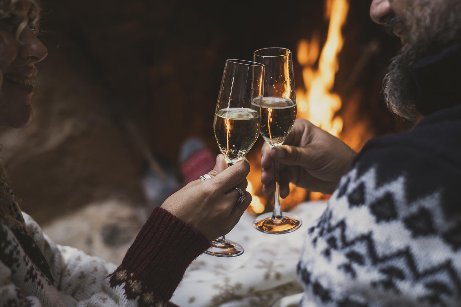 Midsection Of Couple Toasting Wineglasses