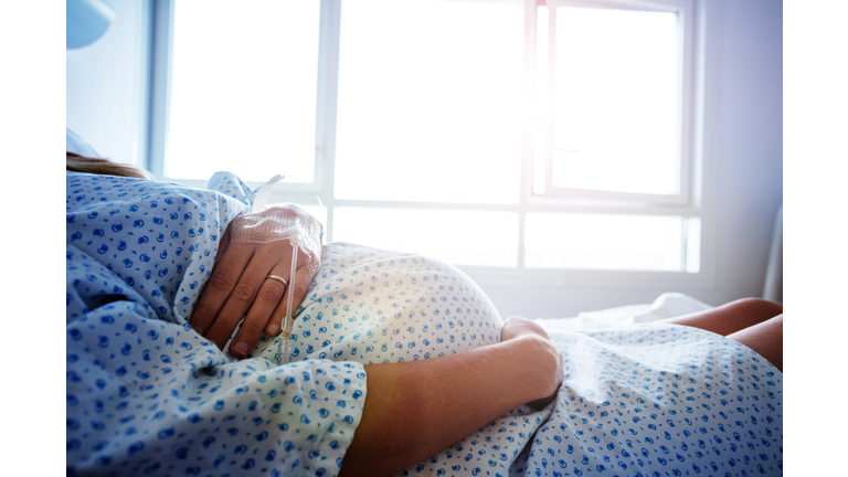 Close-up of a pregnant woman's belly in hospital