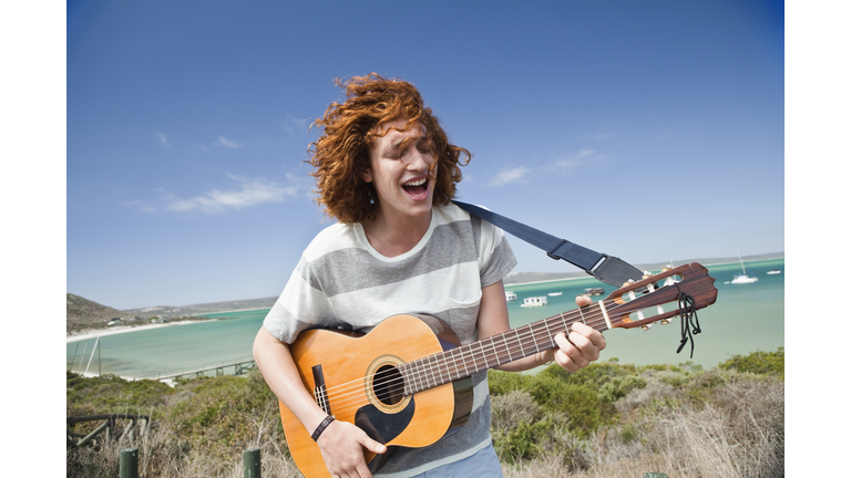 Man playing guitar outdoors