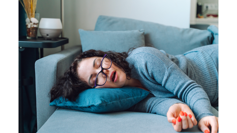 Woman sleep at home on a sofa