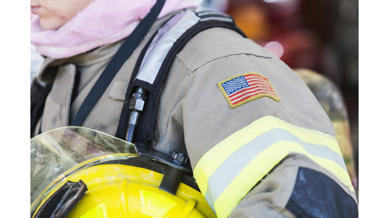 Sleeve of female firefighter with patch of American flag