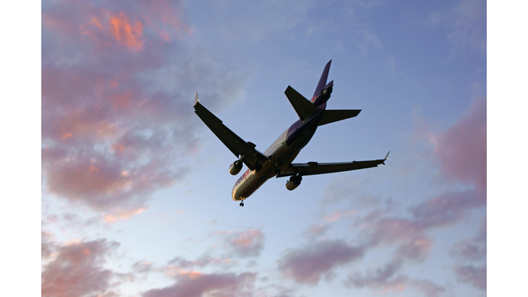 Jet aircraft landing at sunset