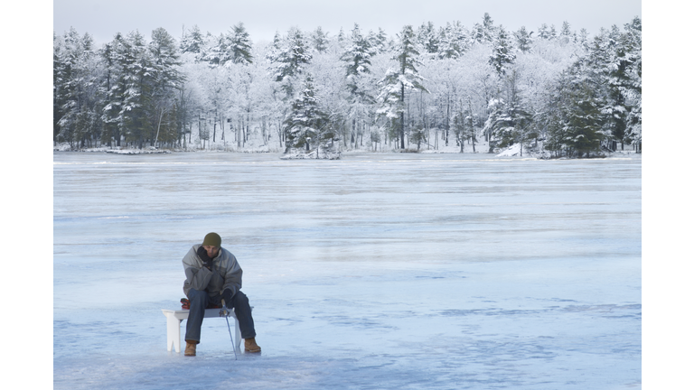 Young man ice fishing