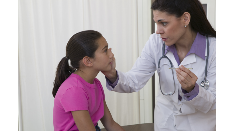 School nurse examining patient