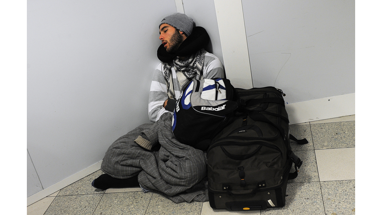 A stranded passenger sleeps at Gatwick a