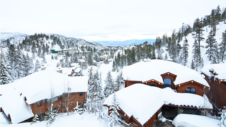 Snow covered houses in the mountains at Lake Tahoe Ski Resort area in the Sierra Nevada range of California.