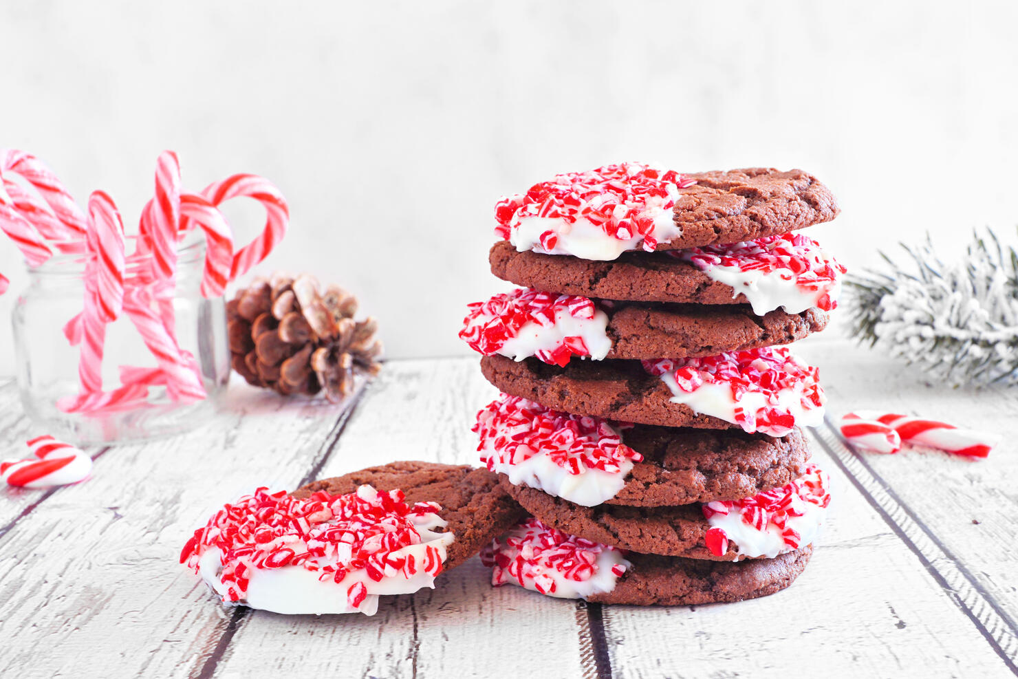 Stack of Christmas chocolate candy cane cookies. Table scene with a white background.