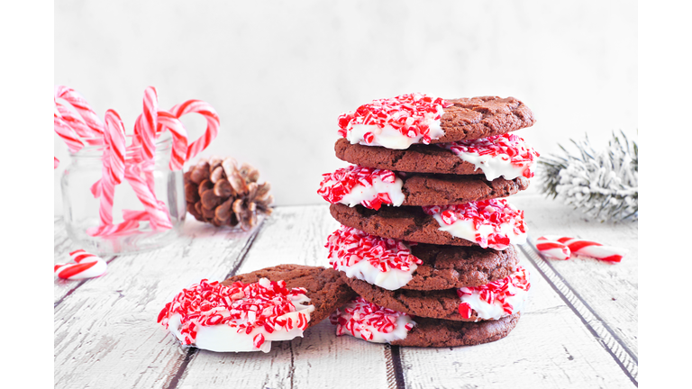 Stack of Christmas chocolate candy cane cookies. Table scene with a white background.