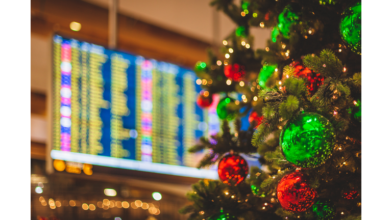 Airport scene - Decorated Christmas Tree with a Flight Departures Display