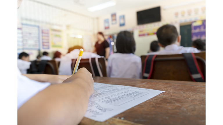 Education concept. The students are holding a pencil to write.