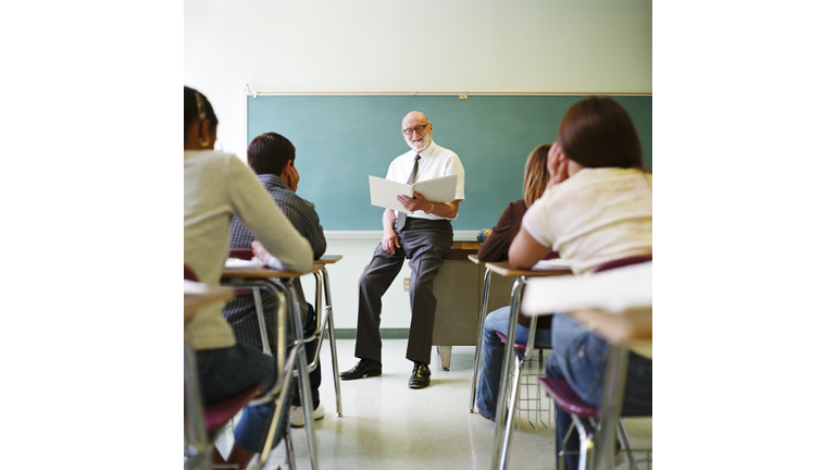 Teacher reading to class of teenagers (14-16)