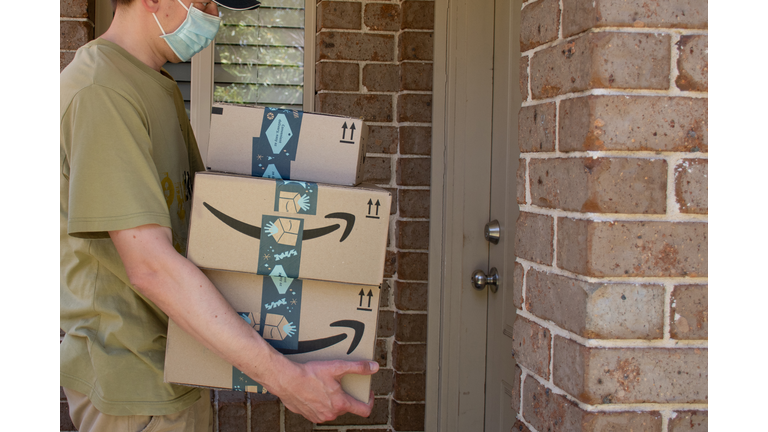 Amazon prime boxes and envelopes delivered to a front door of residential building during the COVID-19 pandemic