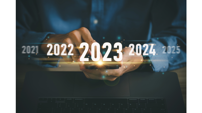 Trend of 2023. Start new year 2023, Businessman investors using mobile phones with a virtual 2023 year diagram, business trends, strategy, investment, business planning, and Happy new year concept.