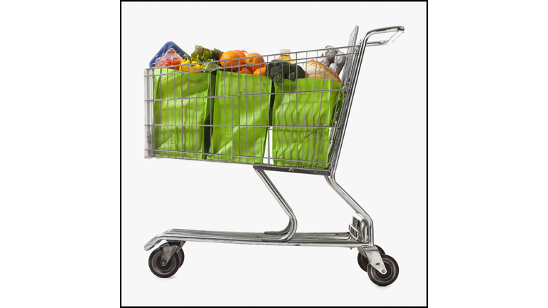 Grocery cart full of bags of groceries