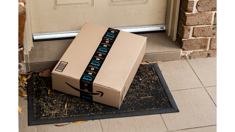 Amazon prime box delivered to a front door of residential building