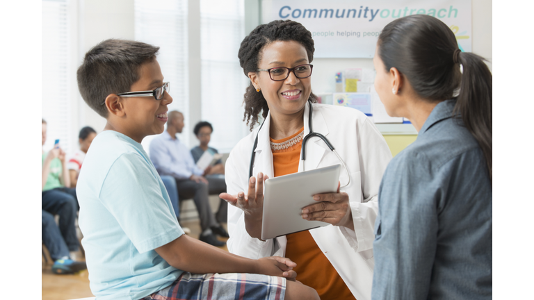 Doctor talking to mother and son in hospital