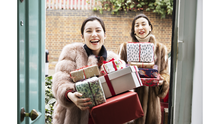 Friends visiting, carrying gifts.