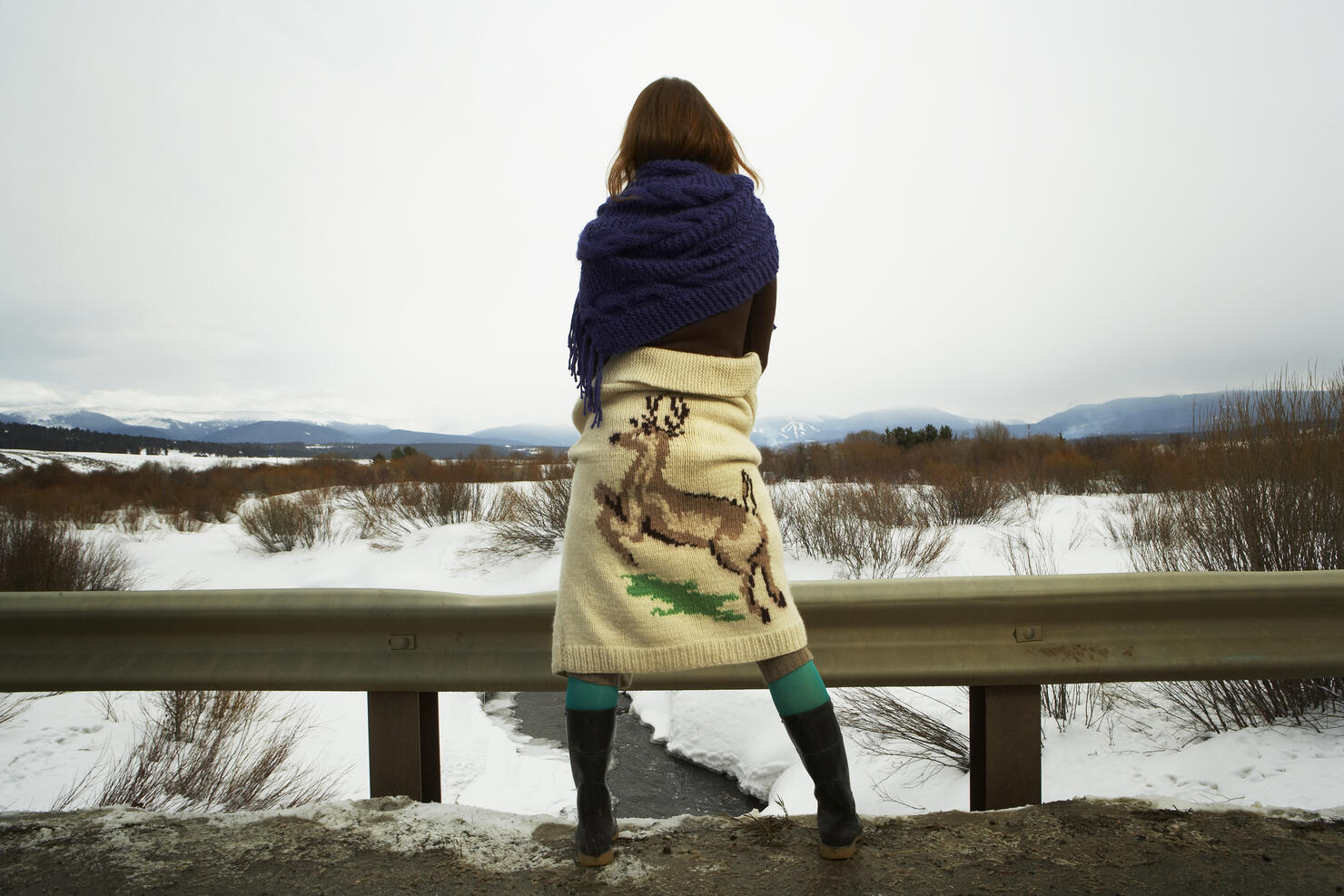 Young woman looking over snowy landscape