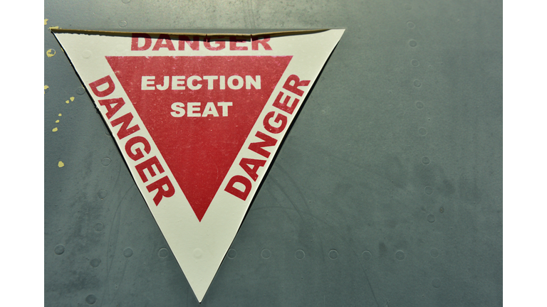 A warning sticker on an old war plane