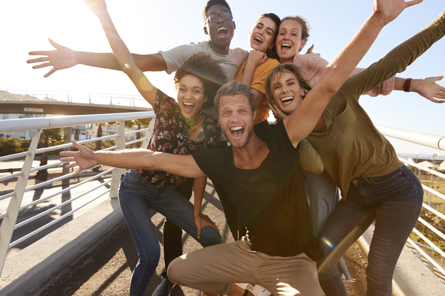Portrait Of Young Friends Outdoors Posing On Gangway Together