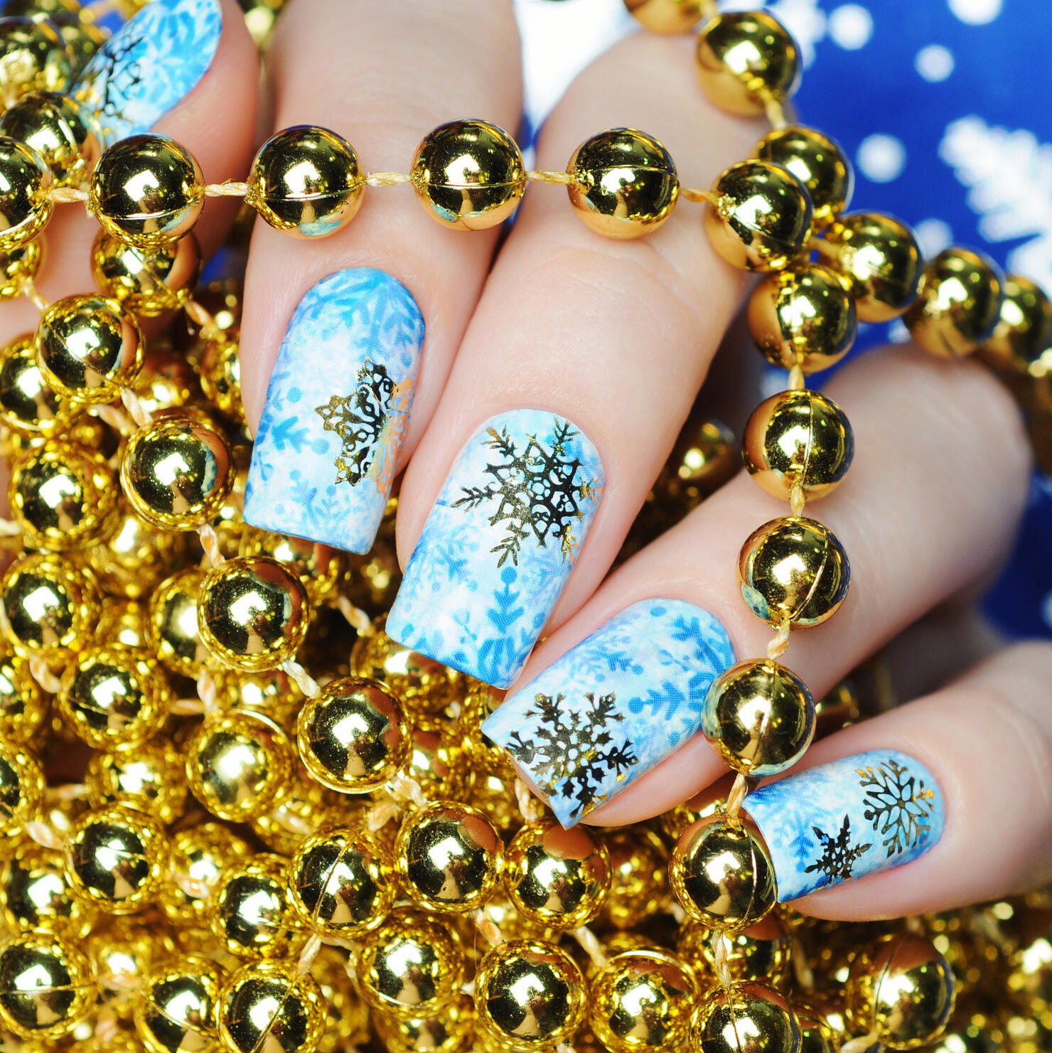 A lovely blue manicure with gold snowflakes!