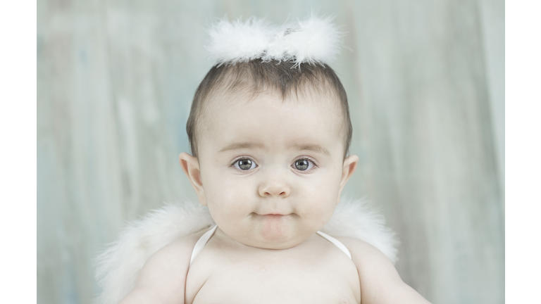 Baby dressed in white angel costume